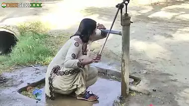 Young village school girl taking a bath in a sari and caught on camera