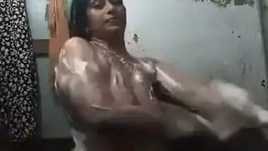 Female with Indian features soaps up her sex parts washing XXX body