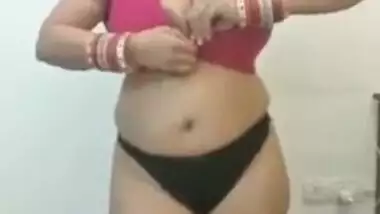 Full-bosomed Indian MILF unbuttons red bra to show her porn pomelos