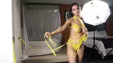 Busty Desi girl poses naked with improvised XXX bondage around body