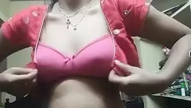Indian girl wears pink bra and red top on camera in her bedroom