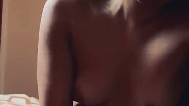 Slim girlfriend smiling while giving handjob and blowjob