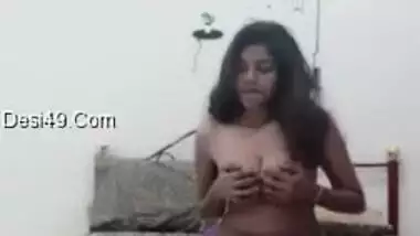 Good-looking Desi girl undresses and plays in bed with her XXX tits