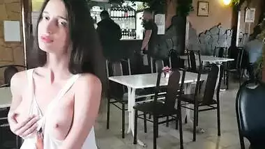 Girl undresses in a bar surrounded by strangers