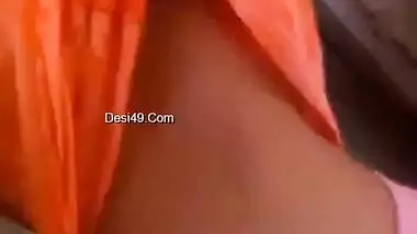 Indian babe in orange takes clothes off to flaunt boobs and buttocks