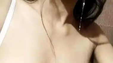 Horny Desi girl spitting on her naked boobs