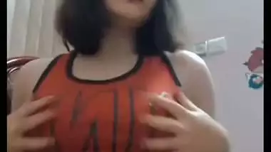Short haired girl playing with her big boobs