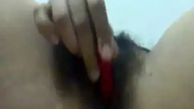 Horny Indian plays with hairy pussy.