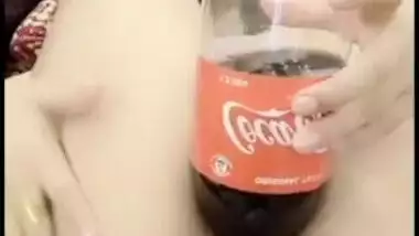 Delhi girl pushes a coca cola bottle in her cunt