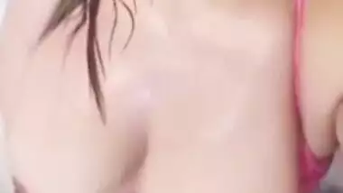 Desi woman with sexy pink lips focuses camera on succulent boobs
